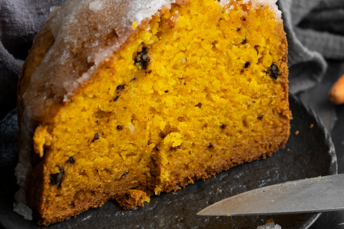 Pumpkin Bread Recipe - A deliciously moist homemade pumpkin bread topped with a sprinkle of cinnamon, presented on a rustic wooden table. Perfect for fall baking and holiday gifting.