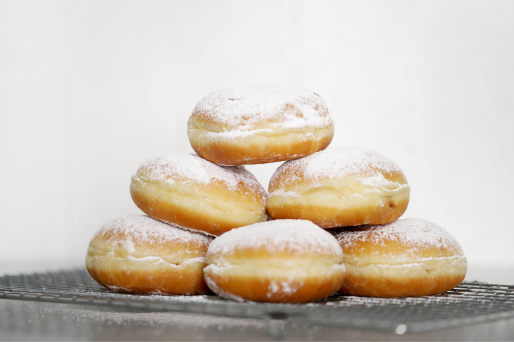 A delicious spread of homemade glazed donuts with a perfect golden-brown crust and glossy icing.